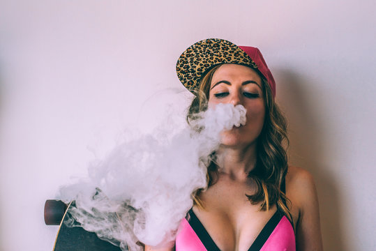 Skater woman smoking a cannabis joint