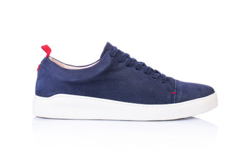 Close up of a blue men's sneakers shoes on white background with reflection. Fashion advertising...