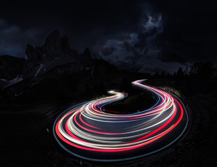 Traffic trails on mountain pass at night