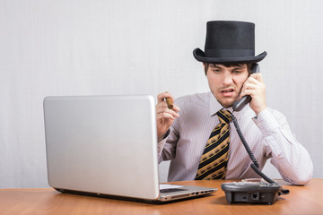 The guy in the hat is talking on the phone