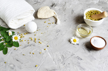 Fototapeta na wymiar Dried chamomile flowers, natural ingredients for homemade body, face salt scrub, mask, SPA concept