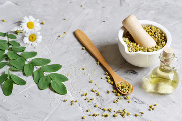 Dried chamomile flowers, natural ingredients for homemade body, face salt scrub, mask, SPA concept