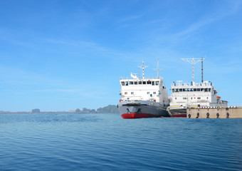 The water transport is at a ship pier. The tugboat and the icebreaker are made fast to the bank in a navigation season.