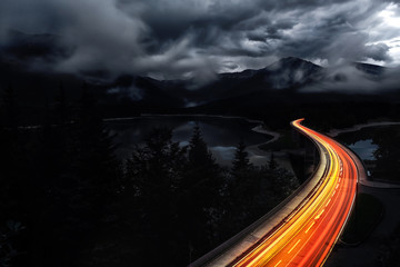 Traffic trails on mountain pass at night