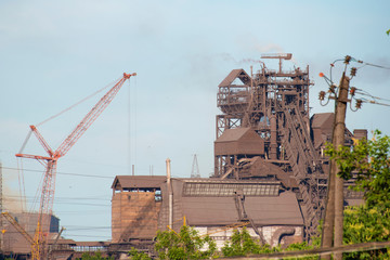 Tower crane on the territory of the plant for the reconstruction of production facilities.