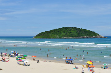  Tourists in the blue sea with green island background