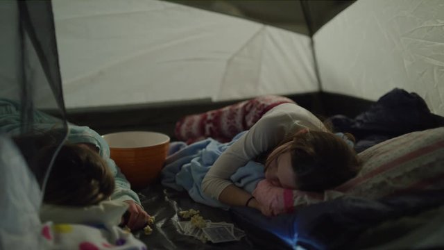 Panning shot of girls sleeping in tent during sleep over / Cedar Hills, Utah, United States