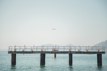 Fototapeta premium the plane is landing to the airport of Corfu at summer day