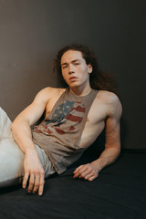 Obraz premium Portraits of a guy with an attractive appearance, curly hair and stylish clothes