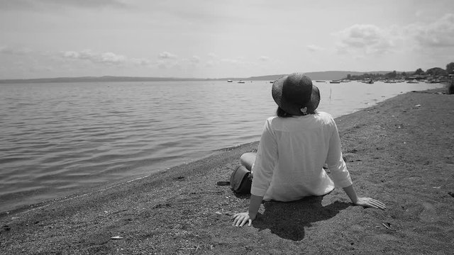 Female tourist enjoying beauty of lake in Italy black and white