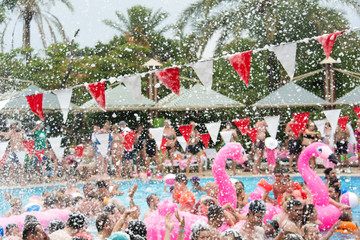 Fototapeta premium Colorful bunting flags on foam party. Selective focus