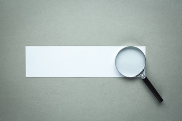 Magnifying glass with blank paper. Search and discover