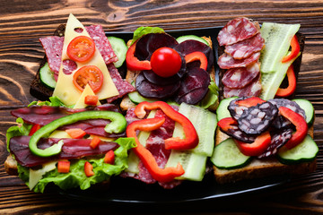 Sandwiches with different meat and vegetables.