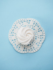 White homemade zephyr on blue isolated background