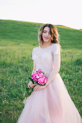 Happy bride in a pink dress