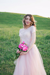 Fototapeta na wymiar Happy bride in a pink dress