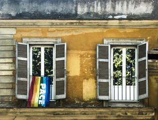 Windows in Rome with rainbow flag with peace