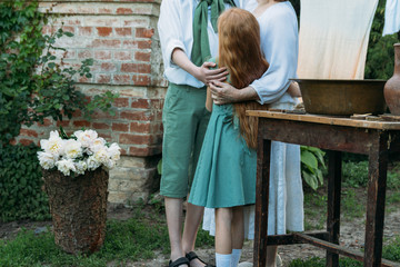 meeting grandmother and grandchildren. grandmother embraces grandchildren, brother and sister. grandson and granddaughter came to visit. give flowers.