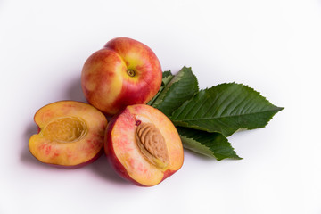 Fresh peaches, nectarines isolated on a white background