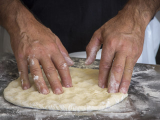 Kneading pizza dough