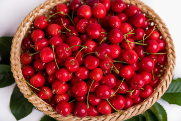 Tasty cherries in a basket isolated on a white background