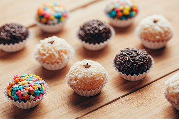 Handmade brazilian sweets: Beijinho and Brigadeiro. Common in children birthday party. Macro, close up
