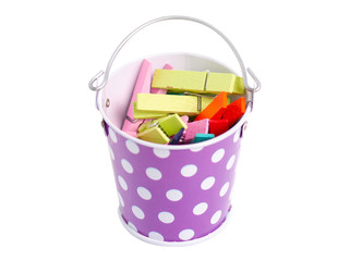 A small bucket with clothespins on a white background isolation