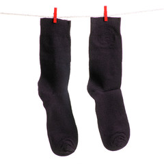 Socks on a rope clothespins on a white background isolation