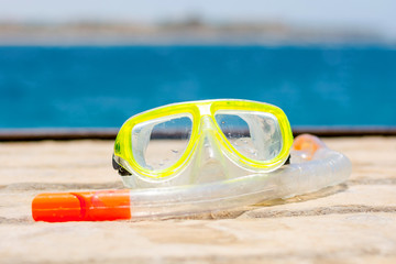 Mask with a tube for snorkling on the background of the sea