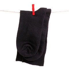 Socks on a rope clothespins on a white background isolation