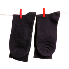 Socks on a rope clothespins on a white background isolation