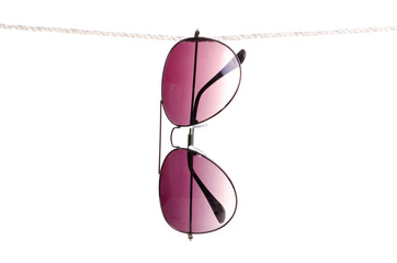Sunglasses on rope clothespin on white background isolation