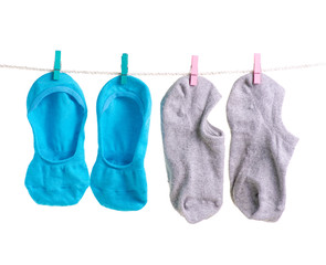 Socks on a rope clothespins no show socks on a white background isolation