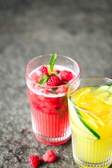 Orange lemonade with cucumber and lemonade with  berries  on the stone desk
