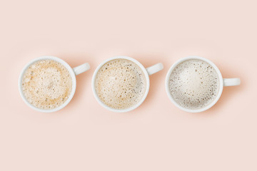 Set of Coffee cups assortment on pale pink background. Flat lay, top view collection
