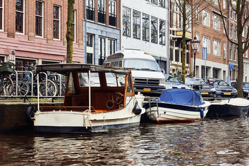 Fototapeta na wymiar Typical dutch architecture, canals and boats in Amsterdam, Holland, Netherlands