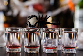 creepy halloween party cocktails with syringes of grenadine syrup as blood, shot drinks at party