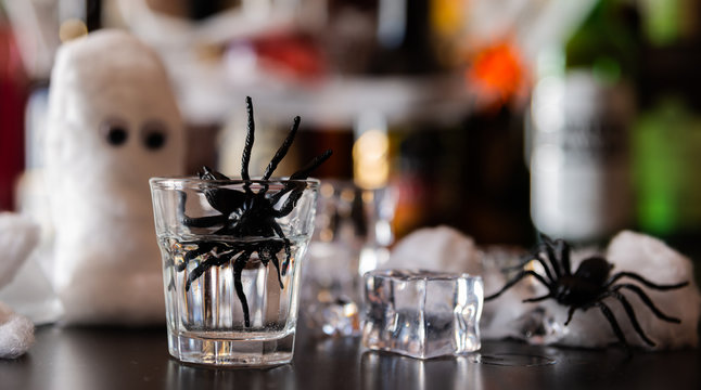 creepy halloween party cocktails with syringes of grenadine syrup as blood, shot drinks at party