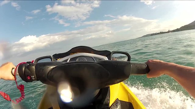 riding a waterbike, near to another one. 