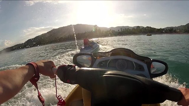 Riding a waterbike on a sunny day, close to a beach