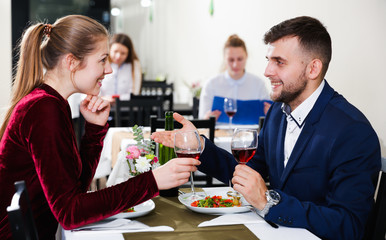 Gentleman with elegant woman are having dinner in luxury restaurante