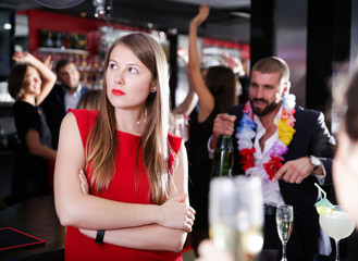 Offended woman with drunk man on party at nightclub