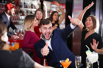Guy expressively dancing in bar