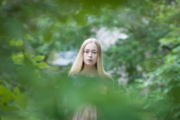 Portrait of young blonde girl in the garden