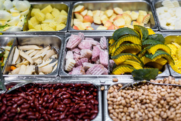 Close up of various vegetables mixed salad bar in supermarket