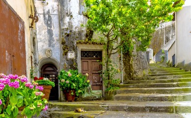Fototapeta na wymiar MARATEA, ITALY - An old staircase in the Maratea adorned with flowers, leads to the Basilica Santa Maria Maggiore in the south of Italy.