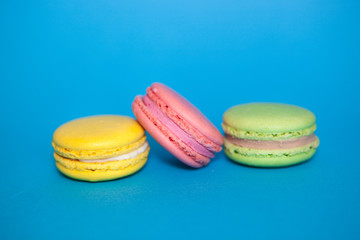 French macaroon biscuits on blue background, sweet food