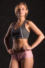 Obraz premium Girl beach volleyball player on a dark background