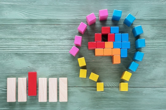 Human brain is made of multi-colored wooden blocks. Creative medical or business concept. Logical tasks.