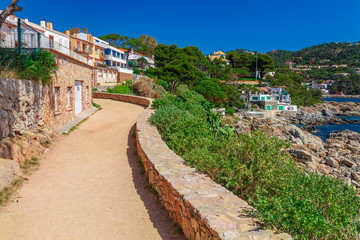 Sea landscape with road near Calella de Palafrugell, Catalonia, Spain near Barcelona. Scenic village with nice sand beach and clear blue water in nice bay. Famous tourist destination in Costa Brava